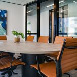 board room table with brown leather chairs