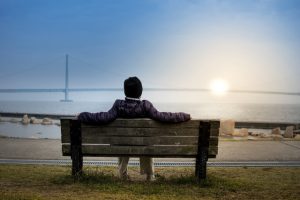 Person relaxing on park bench